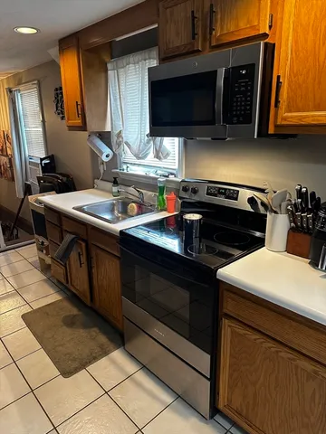 a kitchen with stainless steel appliances granite countertop a sink and a stove