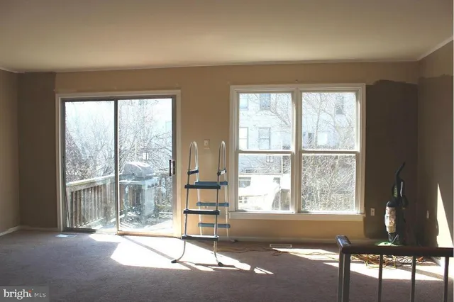 a living room with a floor to ceiling window and floor to ceiling window