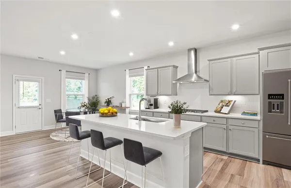 a kitchen with a sink a stove cabinets and counter space