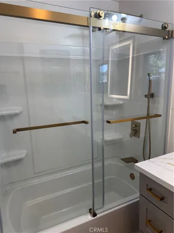 a bathroom with a glass shower door