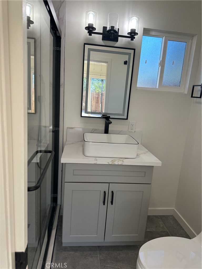 19140 Strathern Street Reseda, CA 91335 - Photo 20 of 33 a bathroom with a sink a toilet and mirror