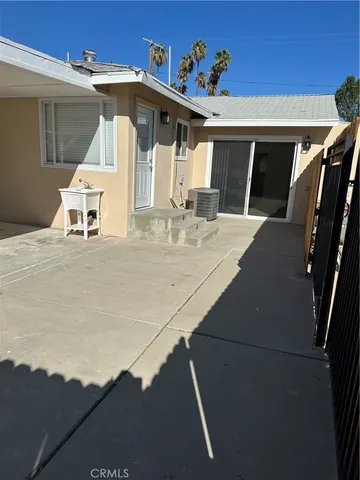 a backyard of a house with table and chairs