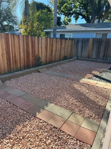 a view of house with backyard and trees