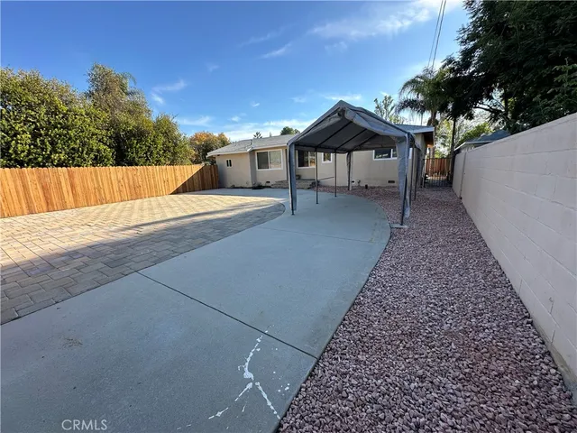 a view of a house with wooden fence