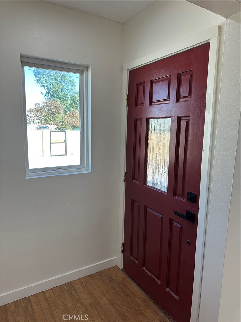 19140 Strathern Street Reseda, CA 91335 - Photo 5 of 33 a view of a hallway with wooden floor and a window