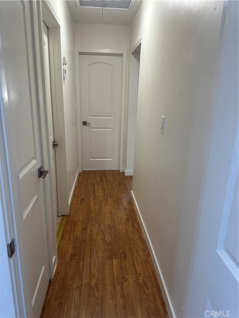 19140 Strathern Street Reseda, CA 91335 - Photo 8 of 33 a view of a hallway with wooden floor