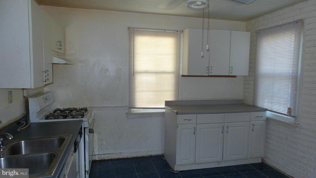 2720 Randolph Road Silver Spring, MD 20902 - Photo 9 of 16 a kitchen with cabinets appliances a sink and a window