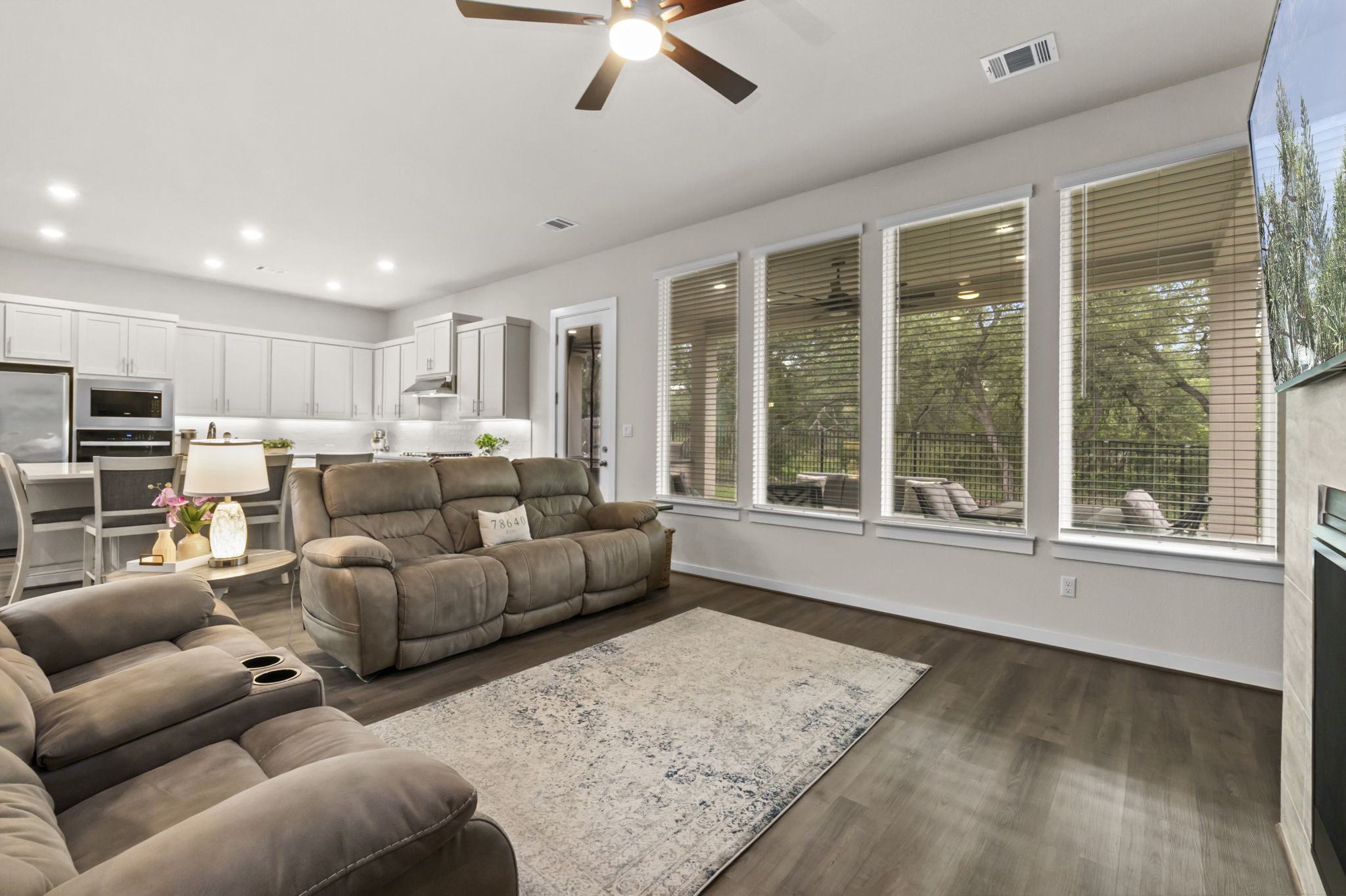 460 Constitution Way Kyle, TX 78640 - Photo 11 of 40 Open-concept living area featuring wood-finish flooring, a contemporary ceiling fan, and recessed lighting