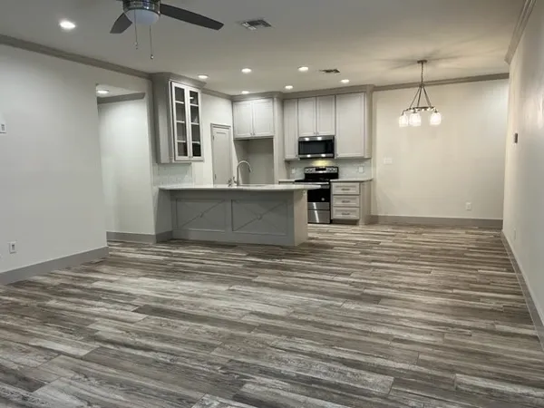 a large kitchen with kitchen island a sink stainless steel appliances and cabinets