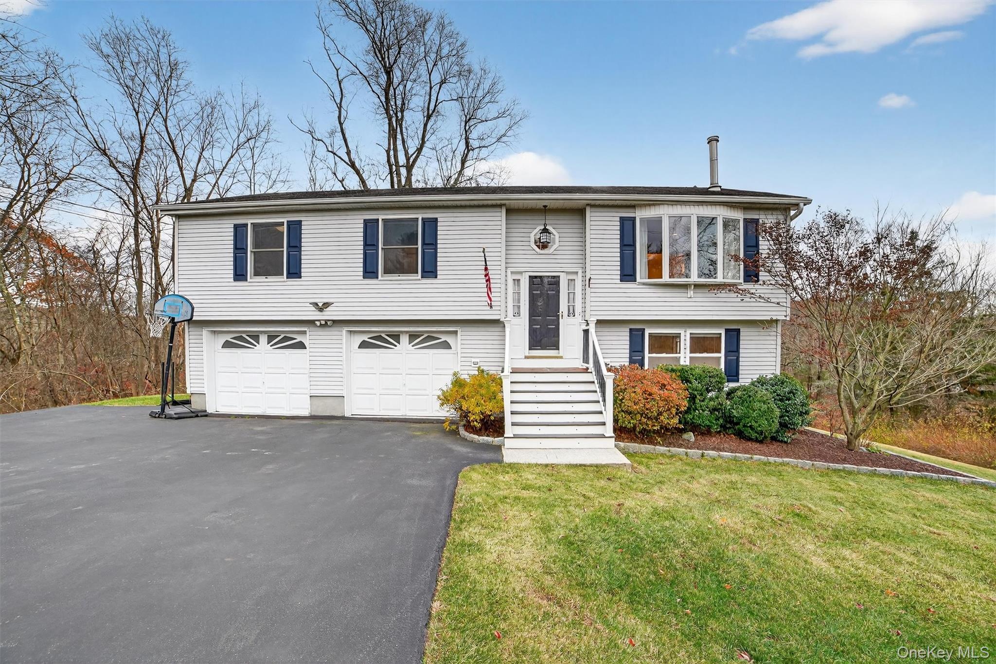 7 Richard Road Mahopac, NY 10541 - Photo 1 of 29 a front view of a house with a yard and garage