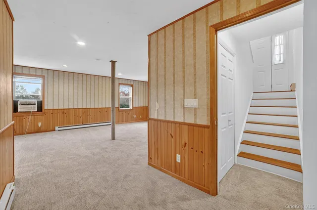 a view of a livingroom with entryway and stairs