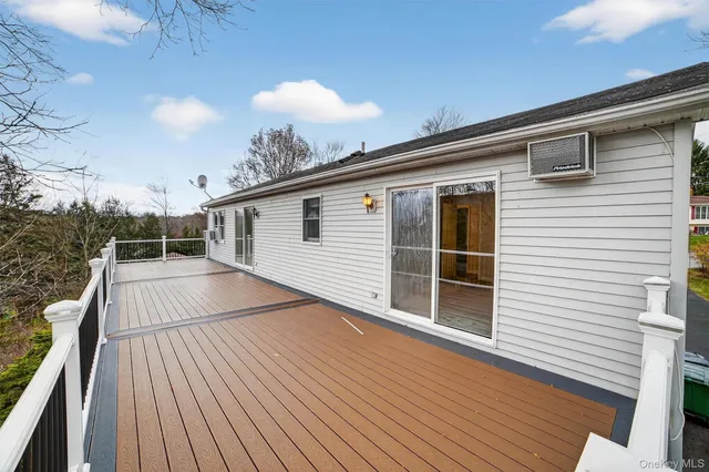 a view of a balcony with wooden floor and fence