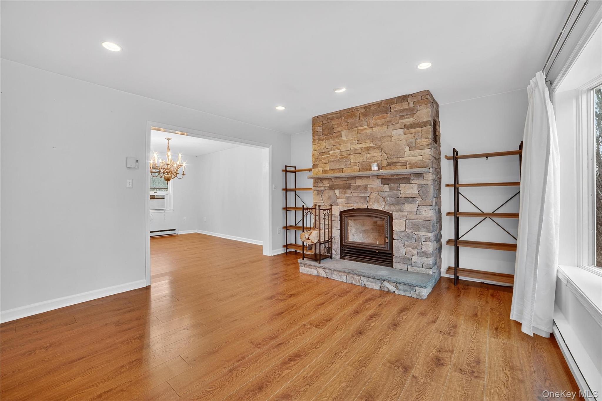7 Richard Road Mahopac, NY 10541 - Photo 4 of 29 an empty room with wooden floor fireplace and windows