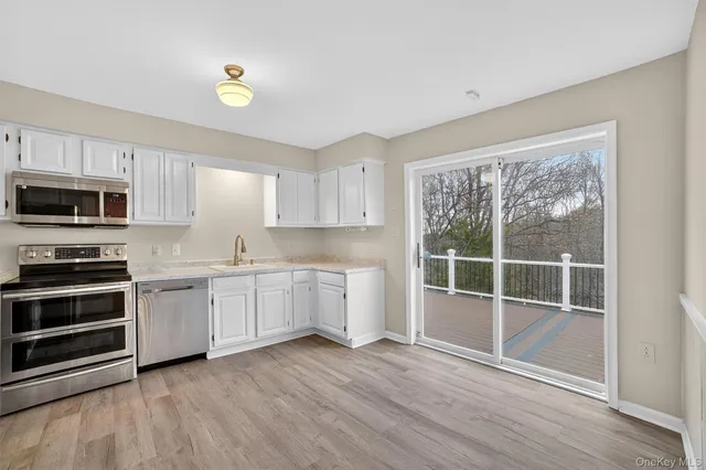 a kitchen with wooden floors and appliances