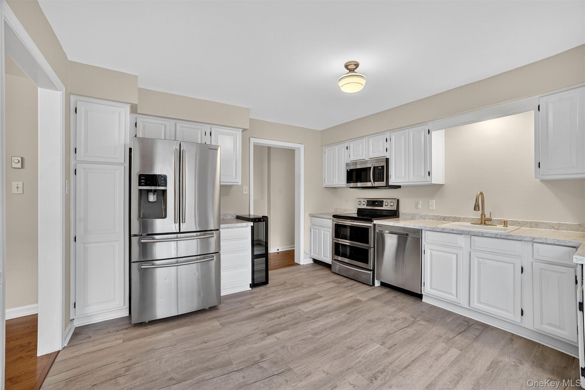 7 Richard Road Mahopac, NY 10541 - Photo 7 of 29 a kitchen with cabinets stainless steel appliances and wooden floor