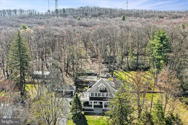 a front view of house with yard and trees in the background