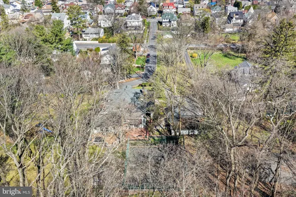 a front view of a house with a garden and swimming pool