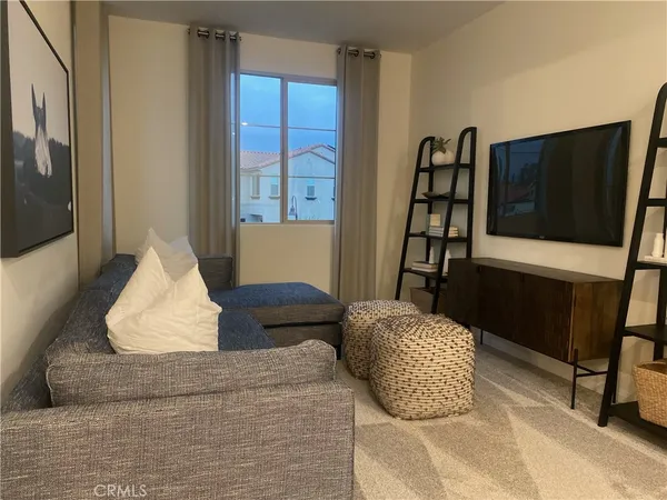 a bedroom with furniture and a window