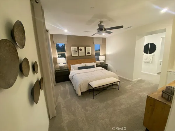 a bedroom with a bed a window and a chandelier