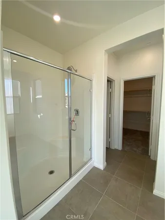 a bathroom with a shower and a glass door