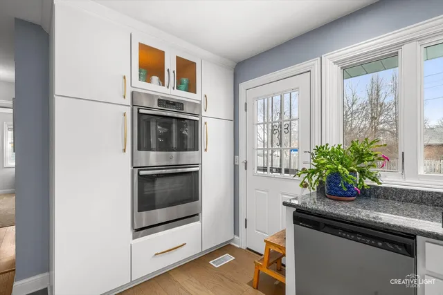 a kitchen with granite countertop a stove and a microwave