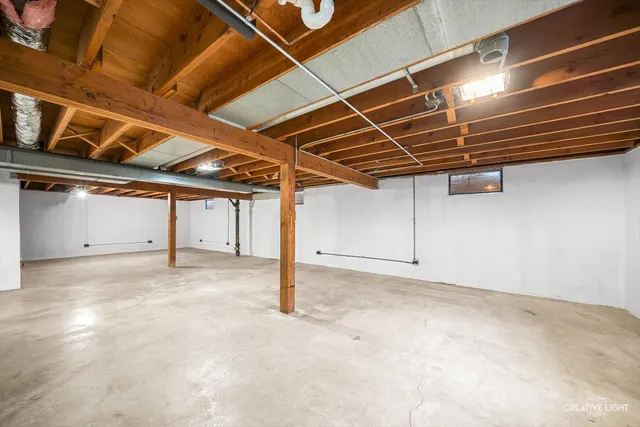 a front view of a house with a garden and trees