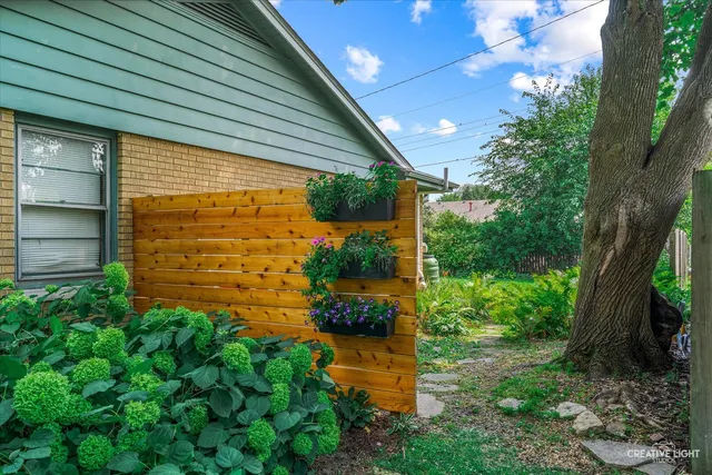 a view of a house with backyard sitting area and garden