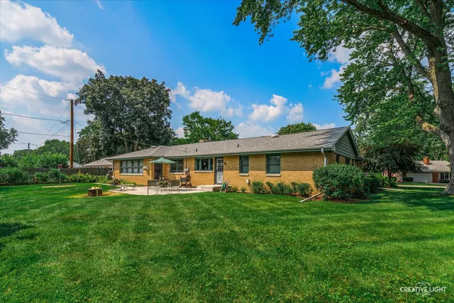 a view of a patio with couches and a table and chairs with garden view