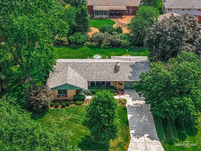 an aerial view of a house with a garden and yard