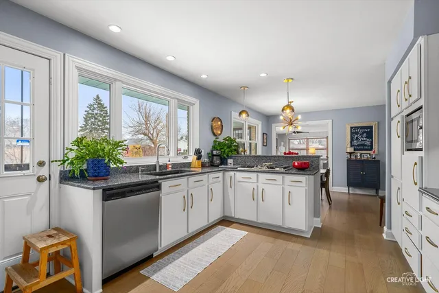 a kitchen with stainless steel appliances granite countertop a stove a sink and a refrigerator