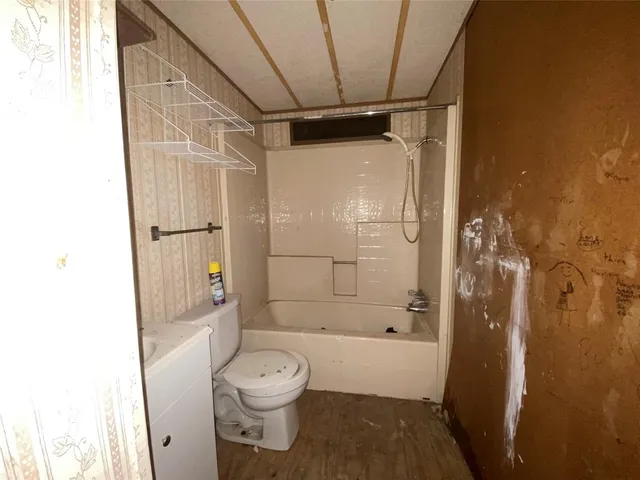 a bathroom with a shower a toilet and a shower