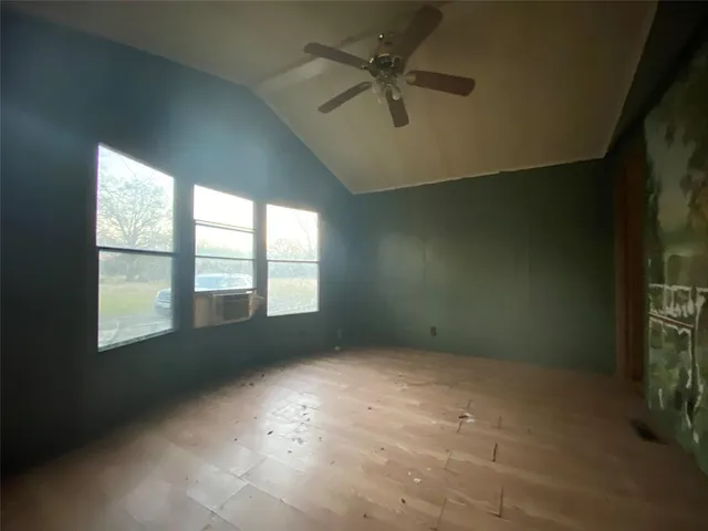 an empty room with a empty space and windows