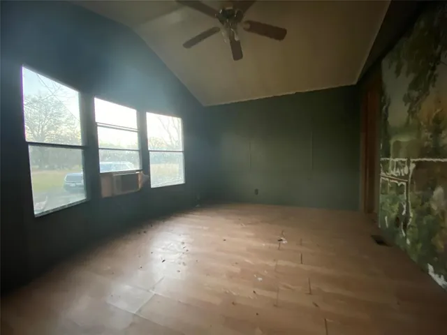 a view of a livingroom with an empty space and a window