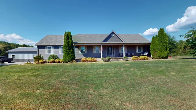 a front view of a house with a yard table and chairs