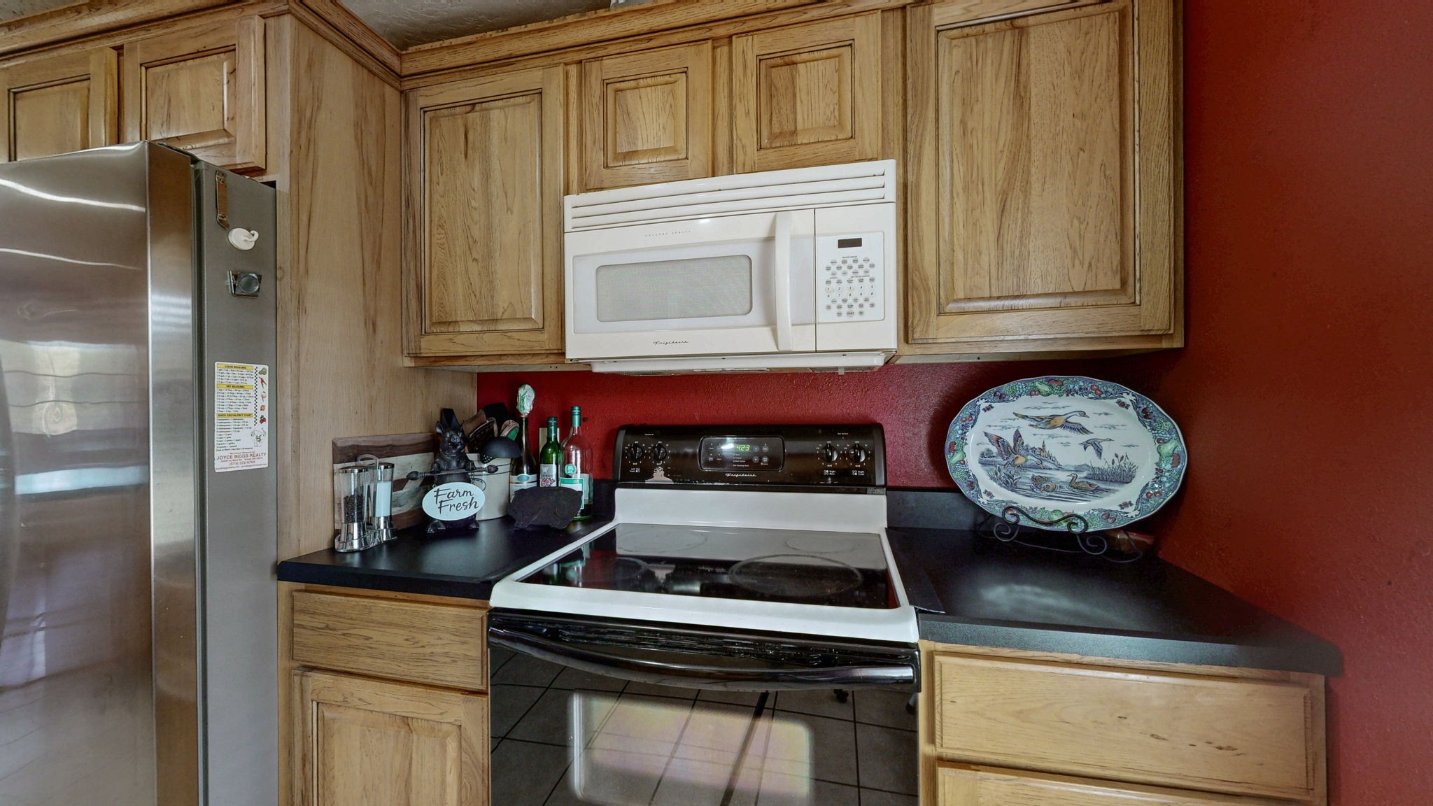 1748 Buffalo Road New Concord, KY 42076 - Photo 12 of 41 a kitchen with stainless steel appliances granite countertop a stove and a refrigerator