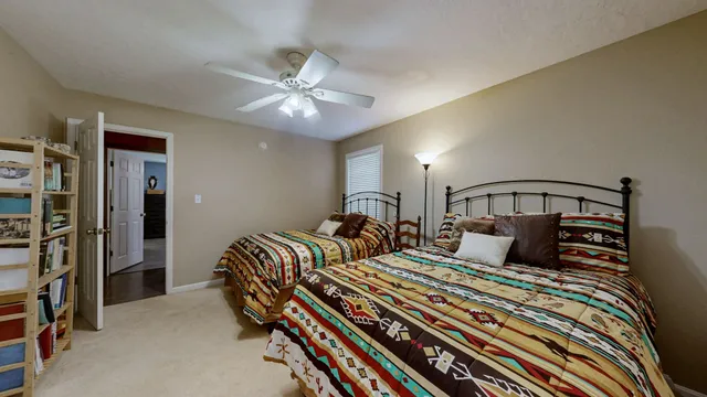 a bedroom with double bed and a chandelier