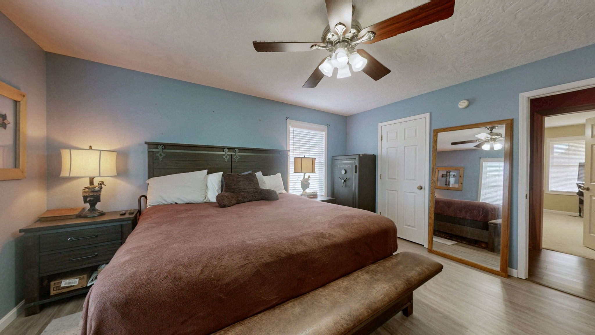 1748 Buffalo Road New Concord, KY 42076 - Photo 21 of 41 a bedroom with a large bed a chandelier and a dresser