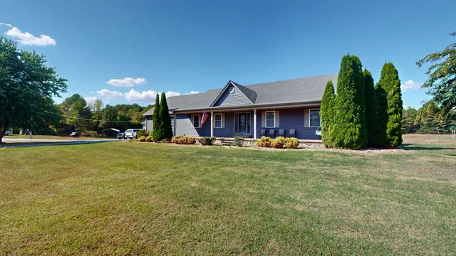 a front view of a house with a yard table and chairs