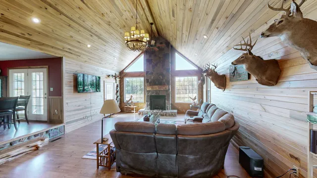 a living room with couches and a fireplace with wooden floor