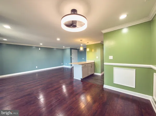 a view of a room with wooden floor and windows