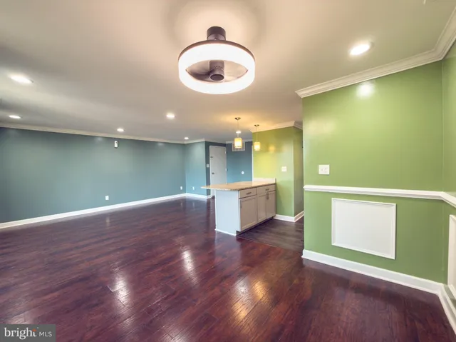 a view of a room with wooden floor and windows