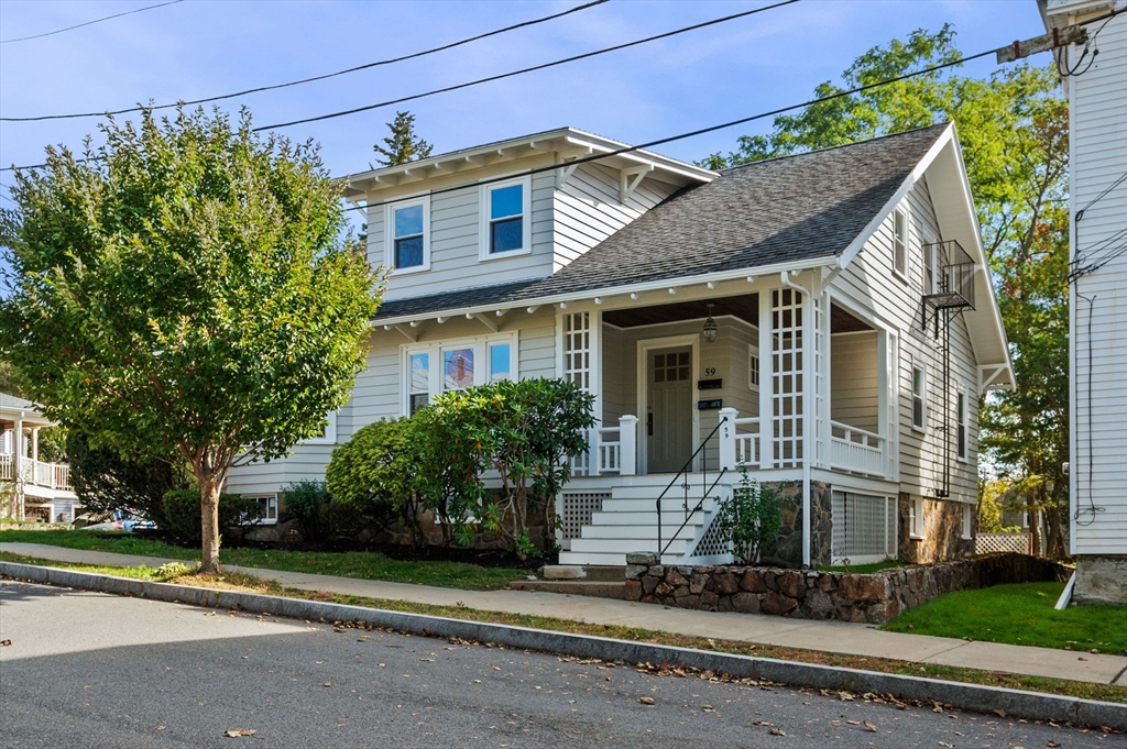 59 Butman Street, Unit 1 Beverly, MA 01915 - Photo 1 of 42 a front view of a house with a garden