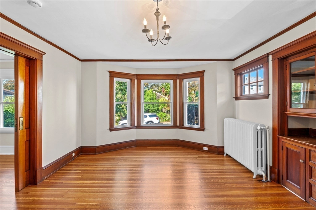 59 Butman Street, Unit 1 Beverly, MA 01915 - Photo 11 of 42 a view of an empty room with wooden floor and a window