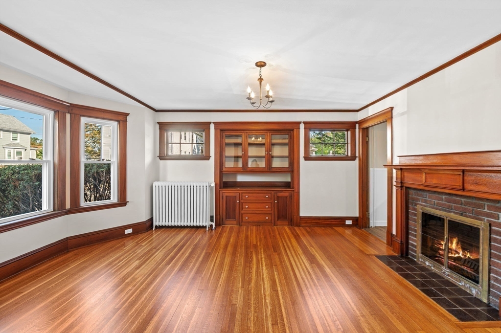 59 Butman Street, Unit 1 Beverly, MA 01915 - Photo 14 of 42 wooden floor fireplace and windows in an empty room