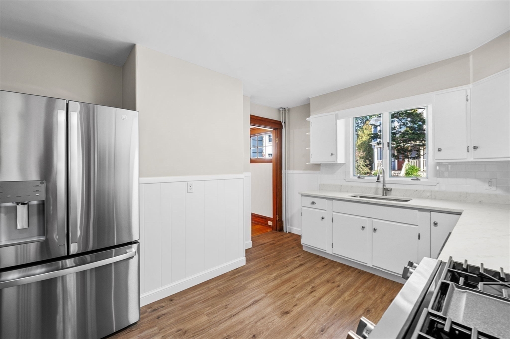 59 Butman Street, Unit 1 Beverly, MA 01915 - Photo 25 of 42 a kitchen with granite countertop a refrigerator stove and sink