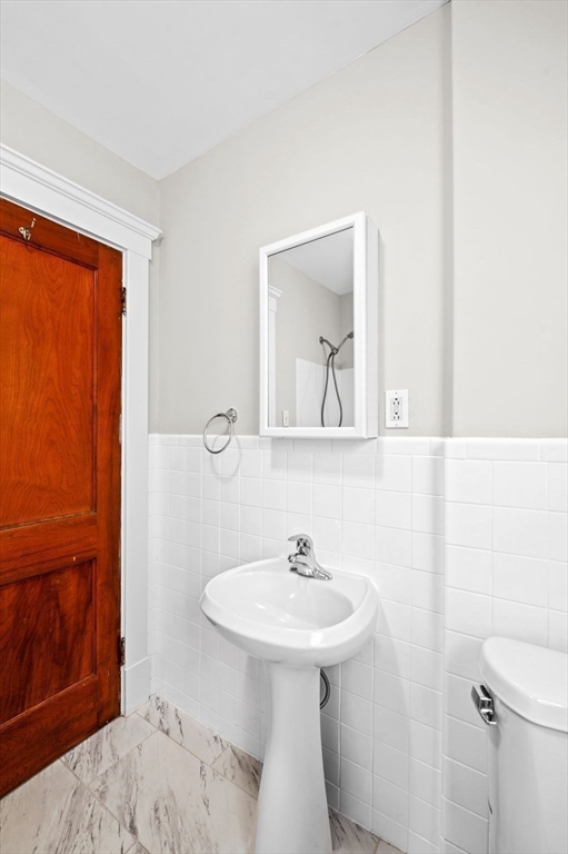 59 Butman Street, Unit 1 Beverly, MA 01915 - Photo 35 of 42 a bathroom with a sink a toilet and shower