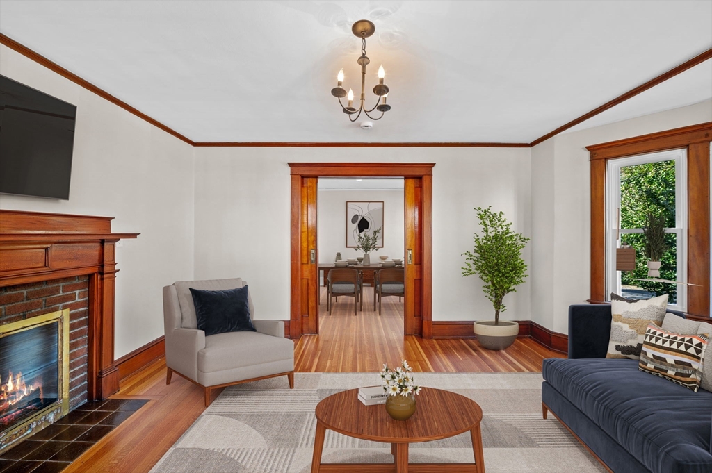 59 Butman Street, Unit 1 Beverly, MA 01915 - Photo 4 of 42 a living room with furniture a window and a fireplace