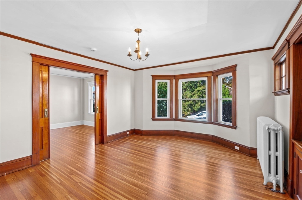 59 Butman Street, Unit 1 Beverly, MA 01915 - Photo 10 of 42 a view of an empty room with wooden floor and a window