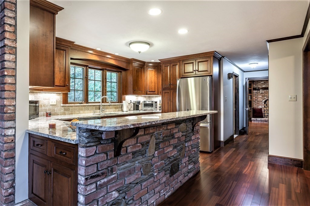 591 Neck Road Rochester, MA 02770 - Photo 14 of 32 a kitchen with granite countertop a stove and a refrigerator