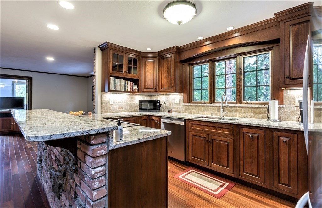 591 Neck Road Rochester, MA 02770 - Photo 15 of 32 a kitchen with a sink and wooden cabinets